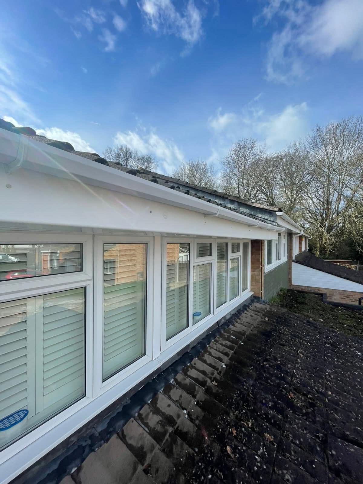 Gutter bracket and outlet at the eaves